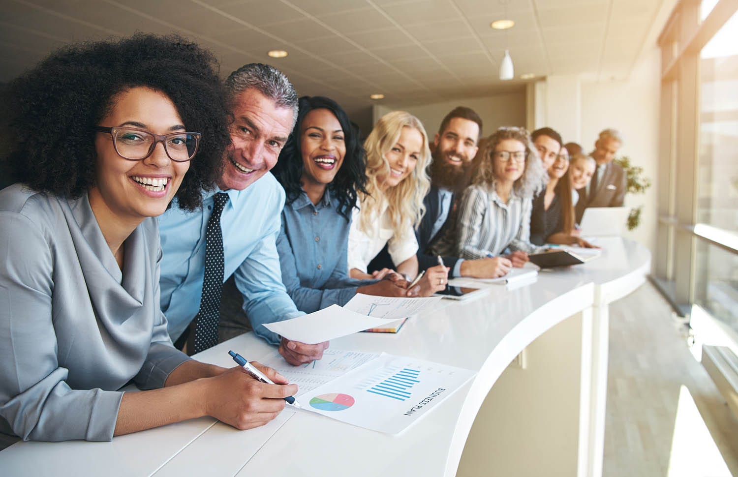 Business professionals standing in line and smiling